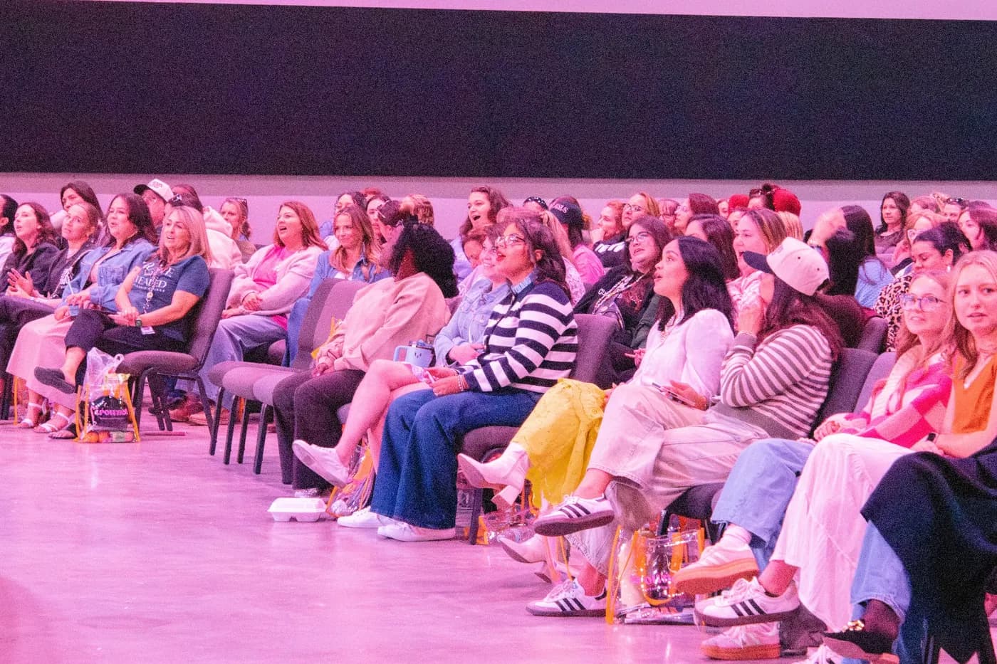 Women seated together listening at the Crowned Women's Conference