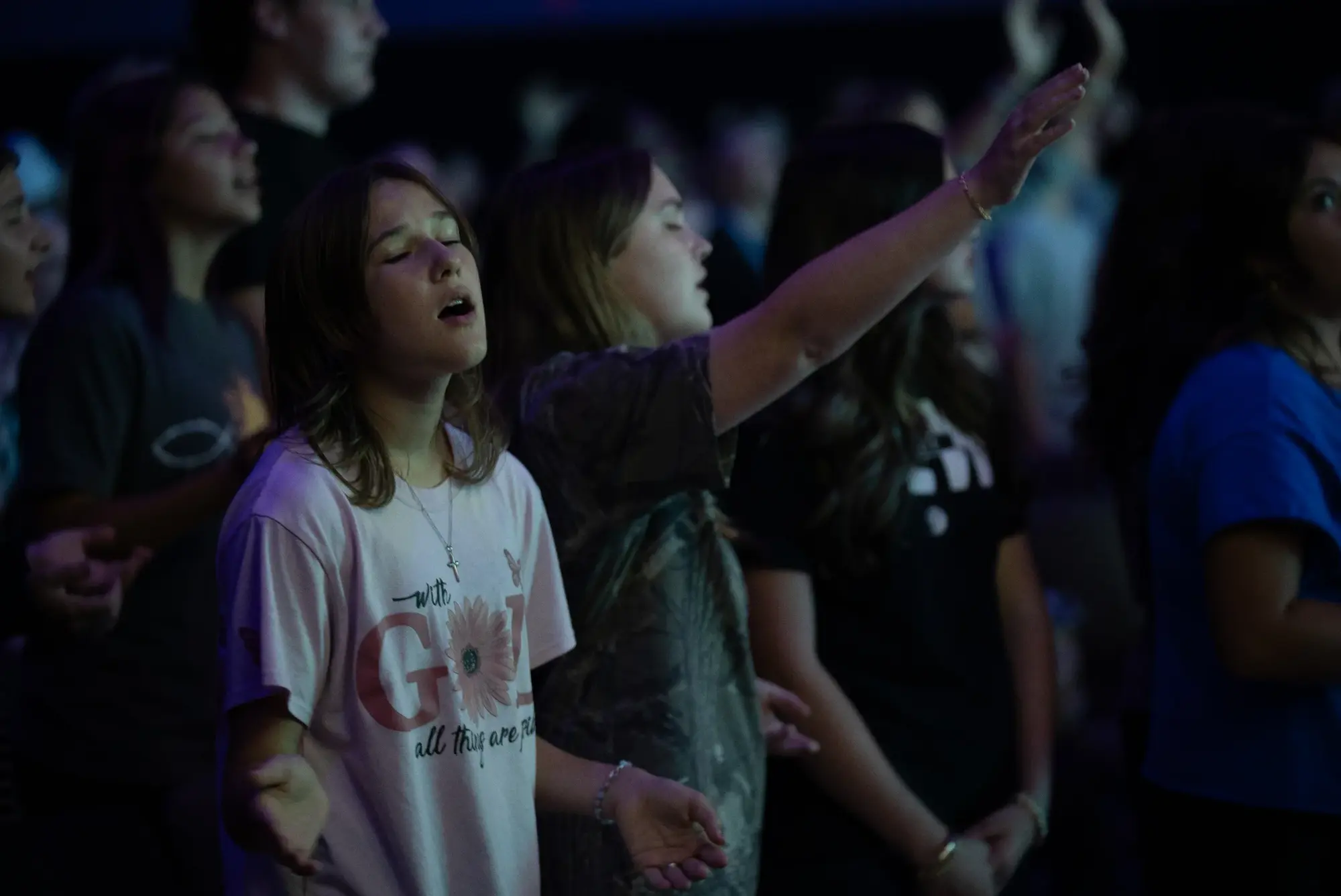 Students worshipping with hands raised at a Vintage Students night