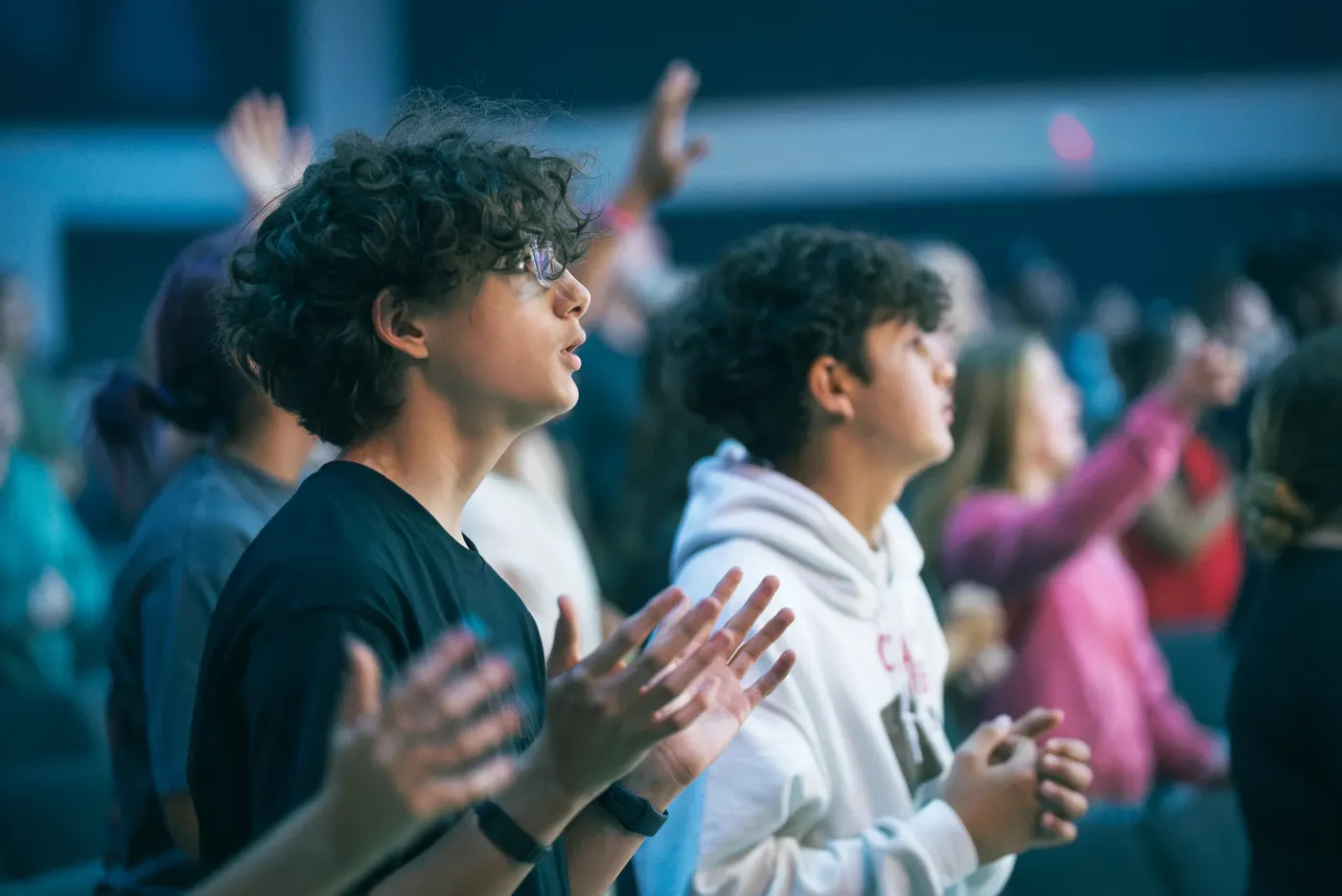 Students worshipping together at a midweek gathering