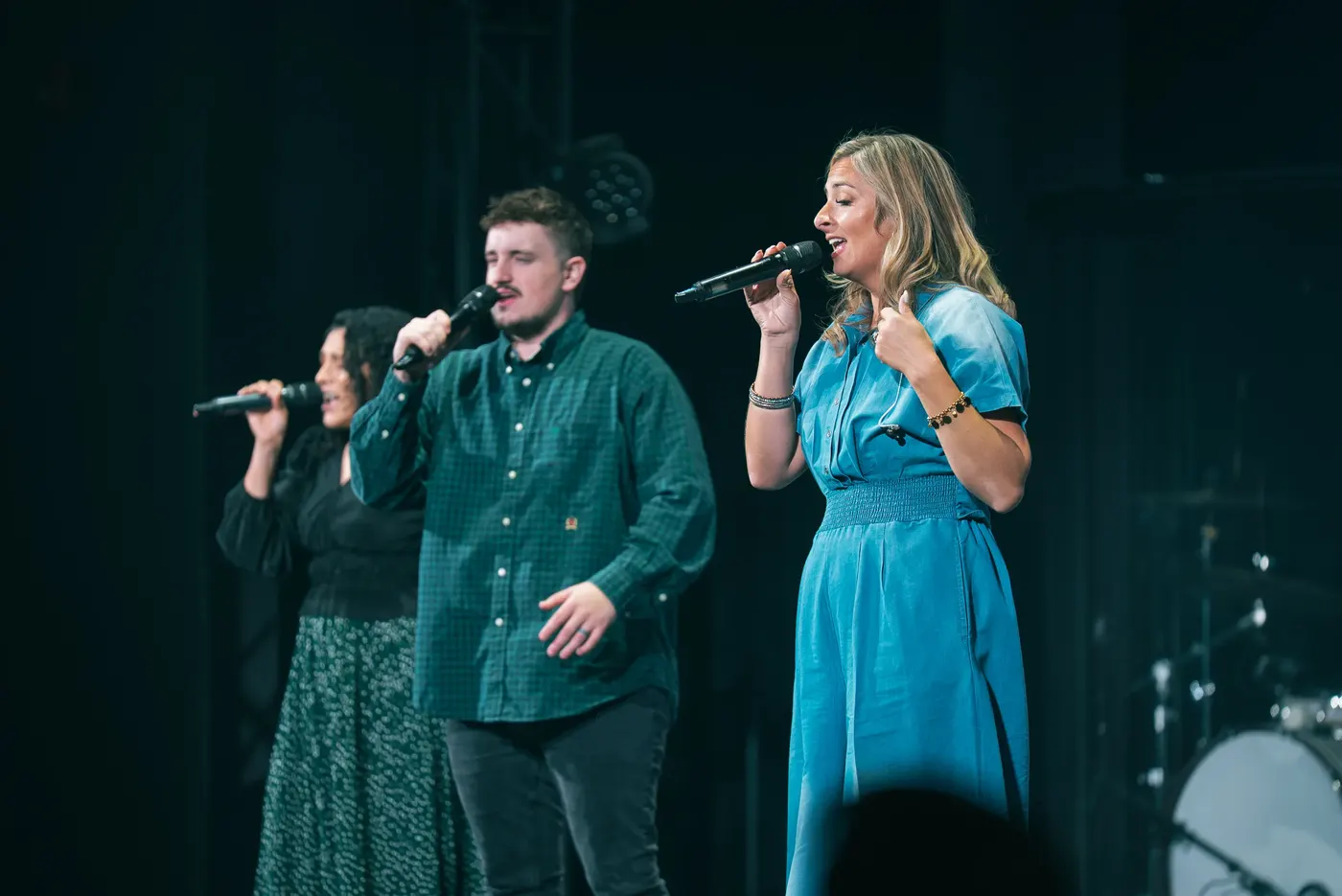 The worship team singing on stage during a Sunday service
