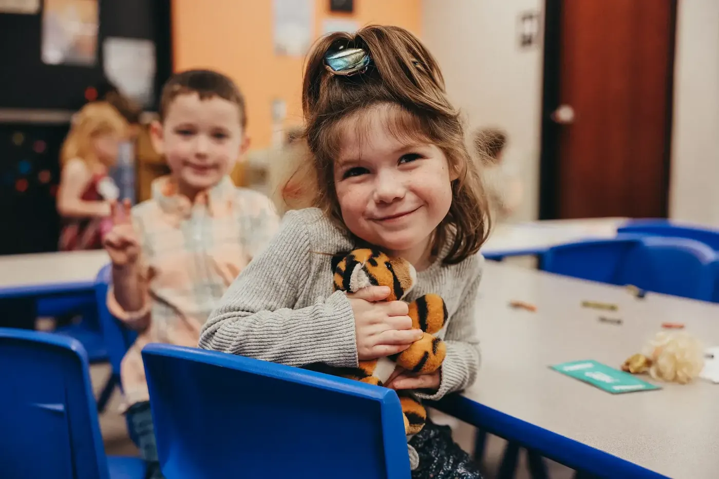 A Vintage Kids girl smiling at a classroom table